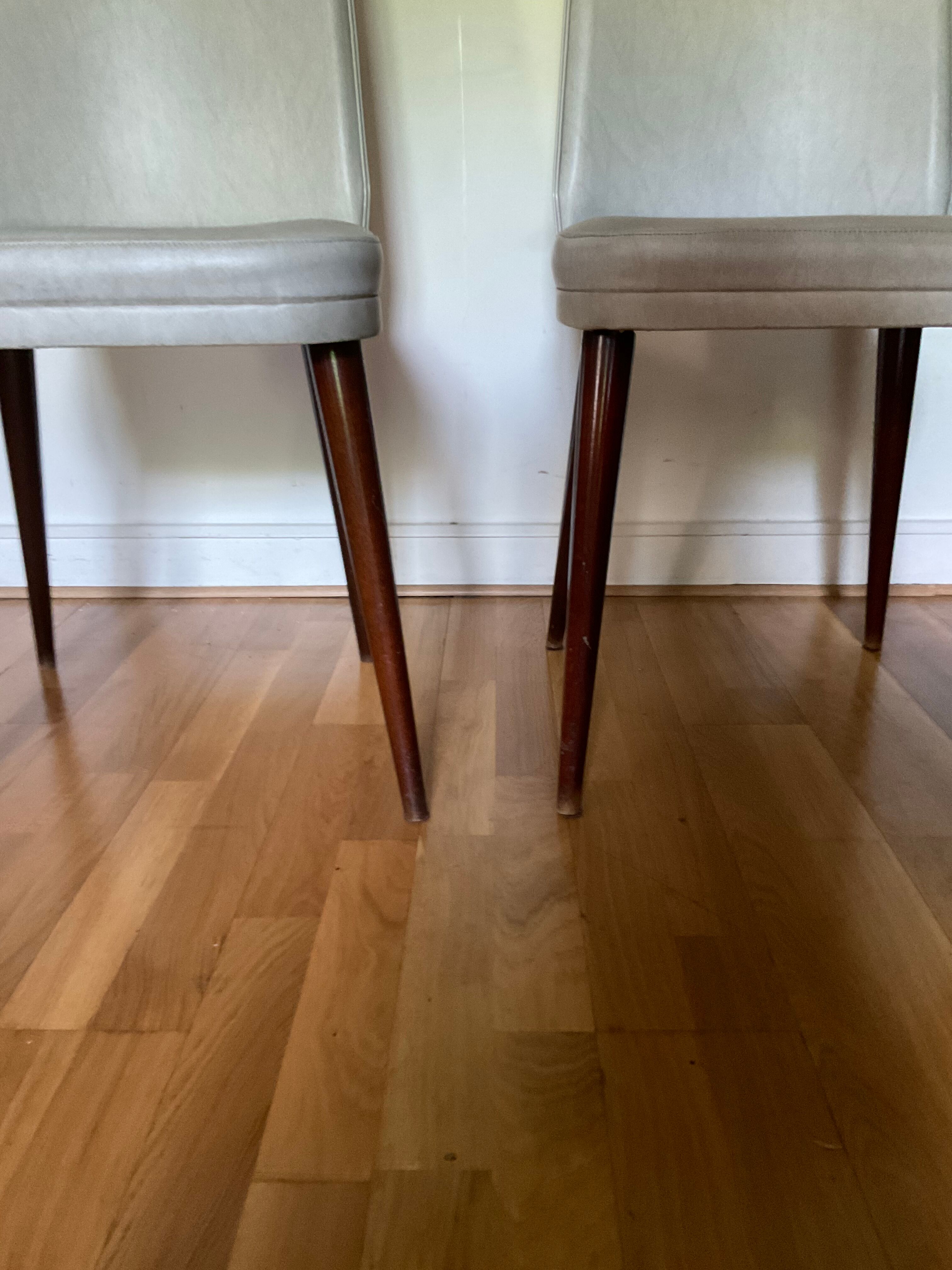 Pair of vintage mahogany and skai chairs