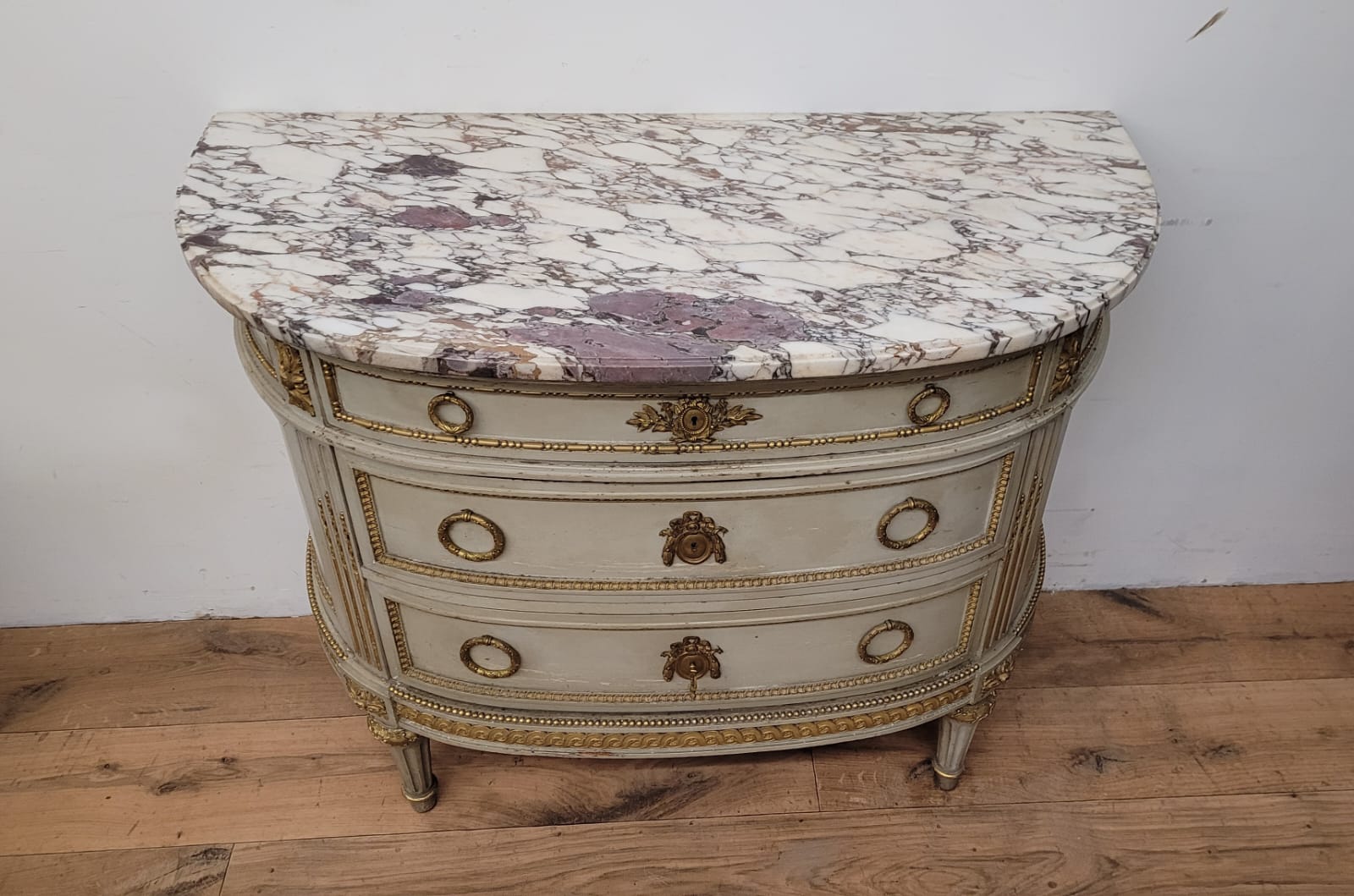 Lacquered half-moon chest of drawers with marble top