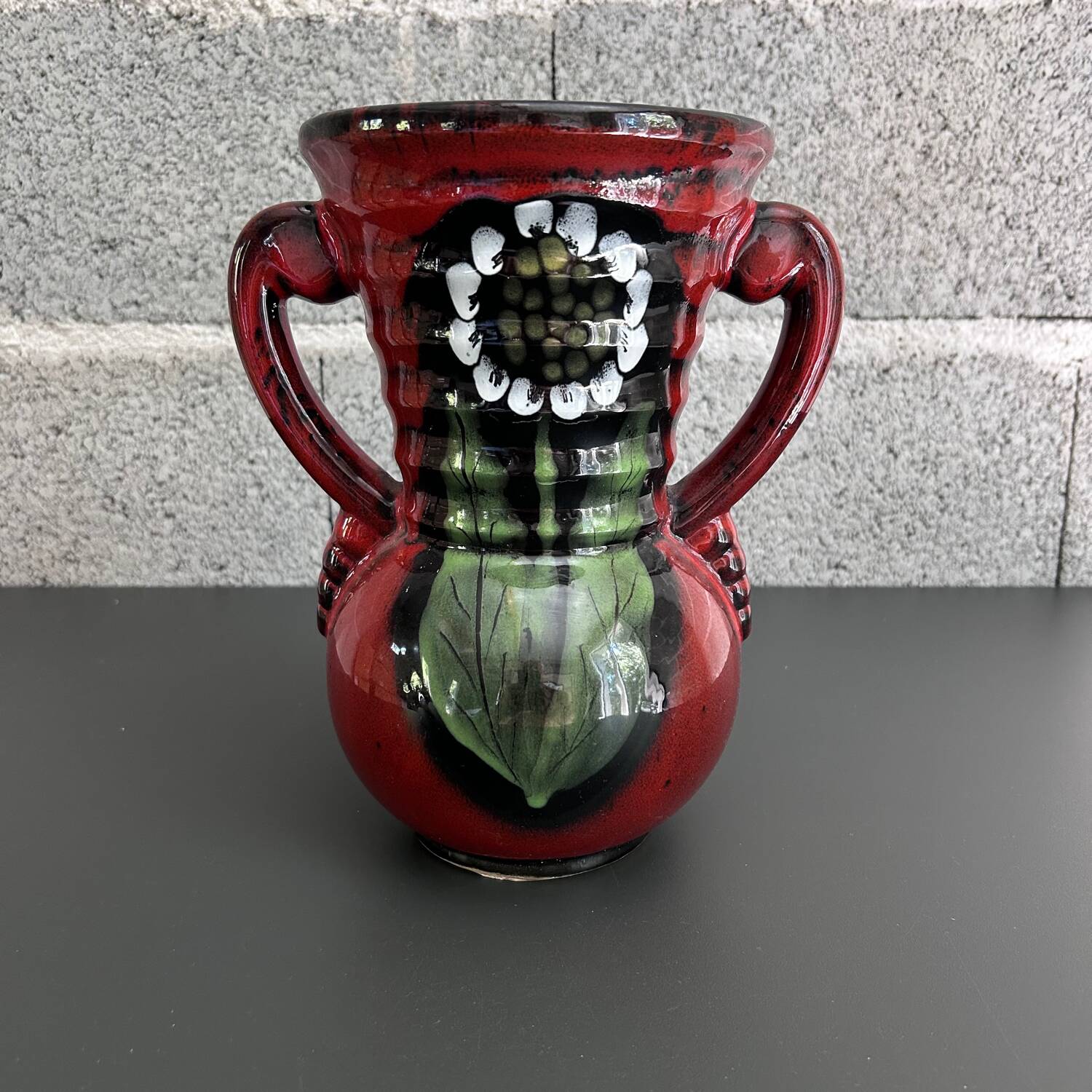 Red vase with floral decoration