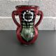 Red vase with floral decoration
