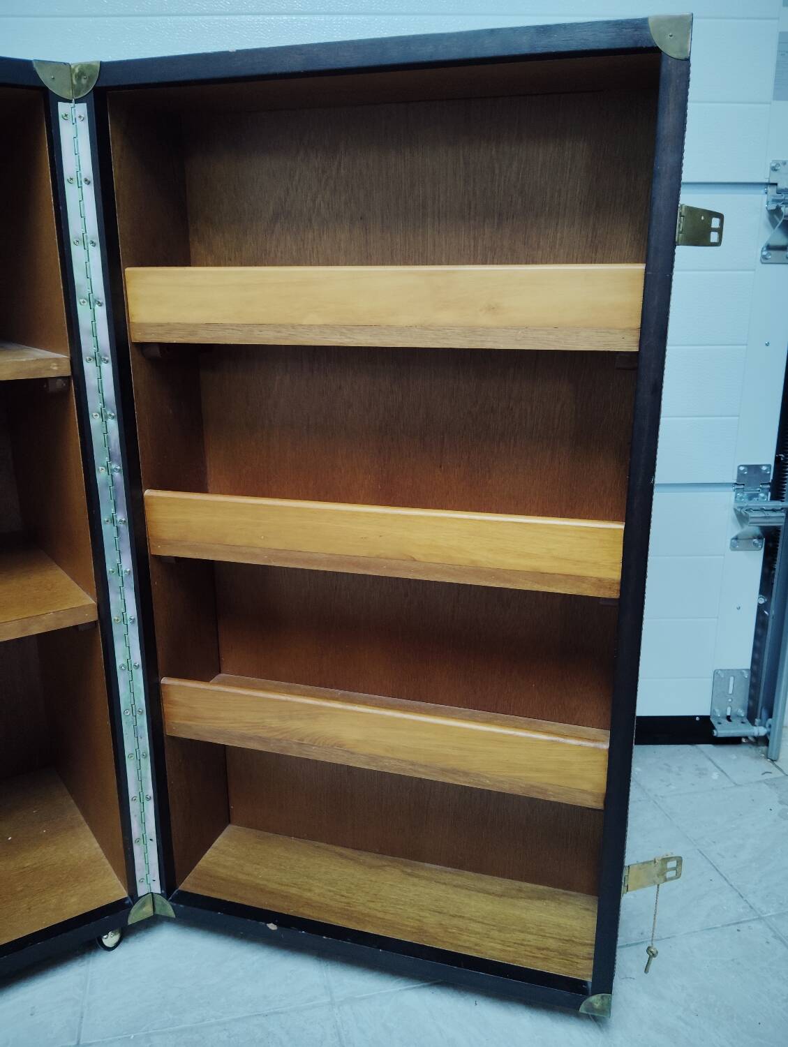 Wardrobe trunk on casters in mahogany and woven rattan.