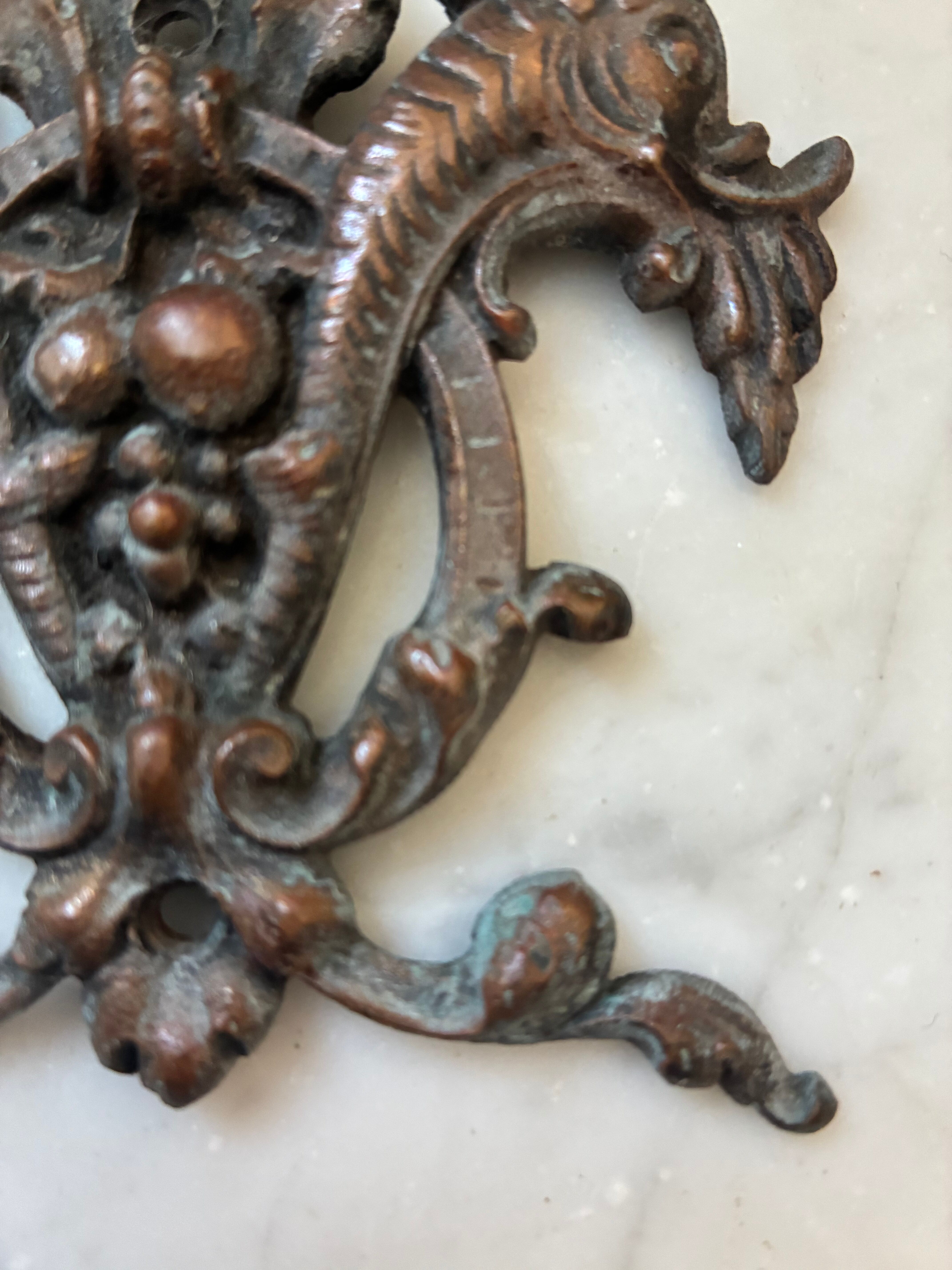 Vintage small furniture ornament in copper alloy with fish decoration.