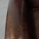 Dark brown sheepskin armchair finished with decorative nails