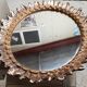 Oval sun mirror made of gilded solid wood