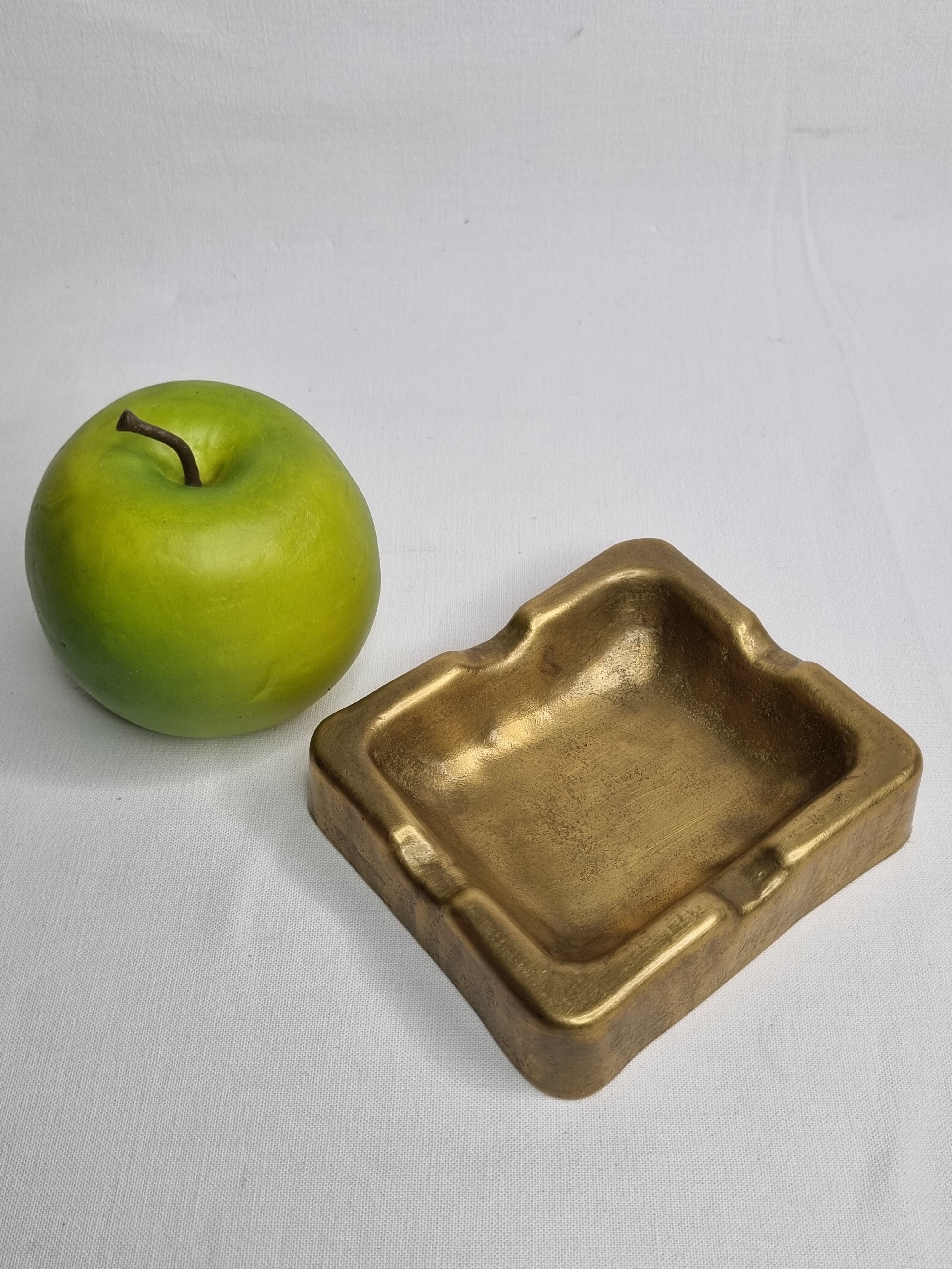Empty pocket brutalist-inspired ashtray in gilded bronze