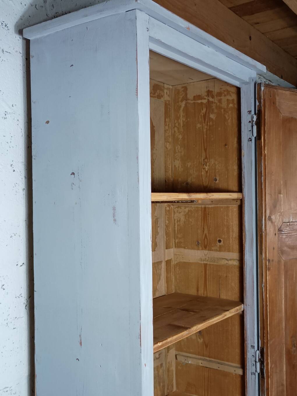 Rustic antique bonnetière in weathered blue-grey wood.