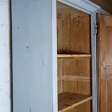 Rustic antique bonnetière in weathered blue-grey wood.