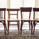 Set of 4 light wood bistro chairs stamped Baumann and Thonet.