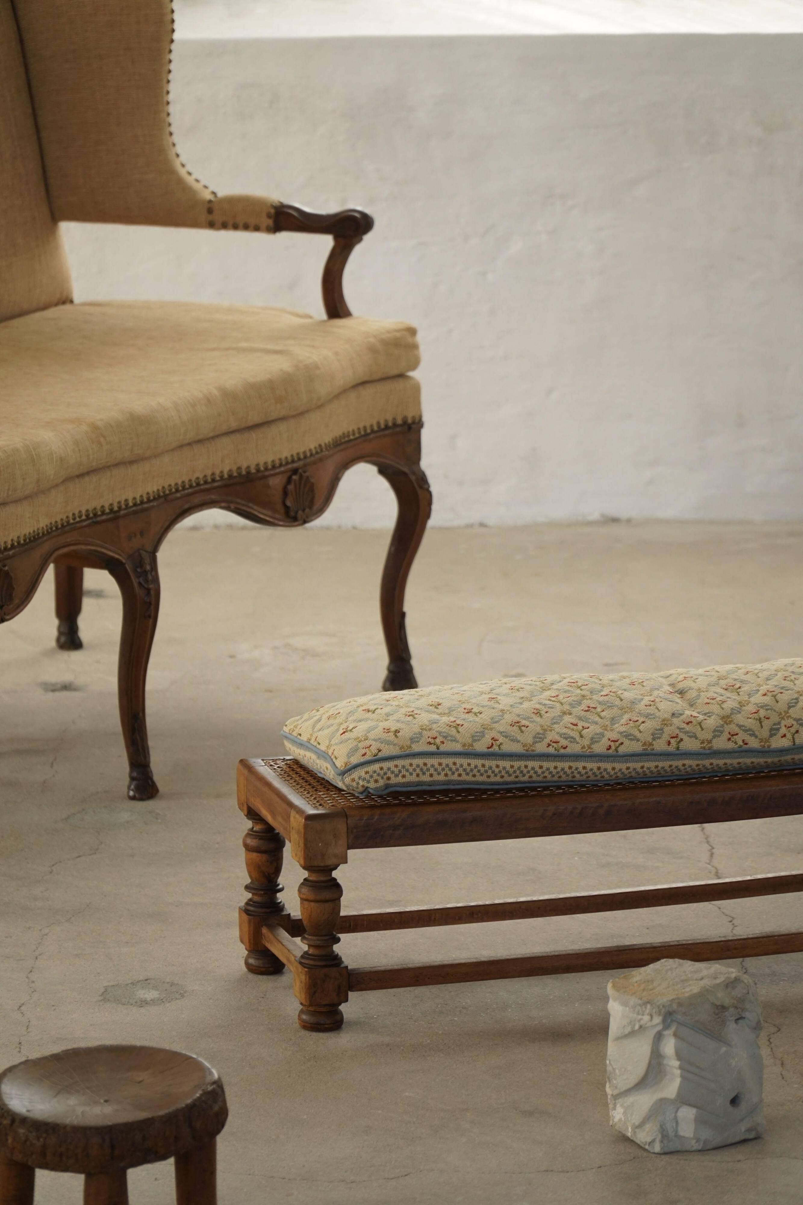 Danish oak footrest with hand-embroidered cushion and rattan seat, baroque, 1940s.