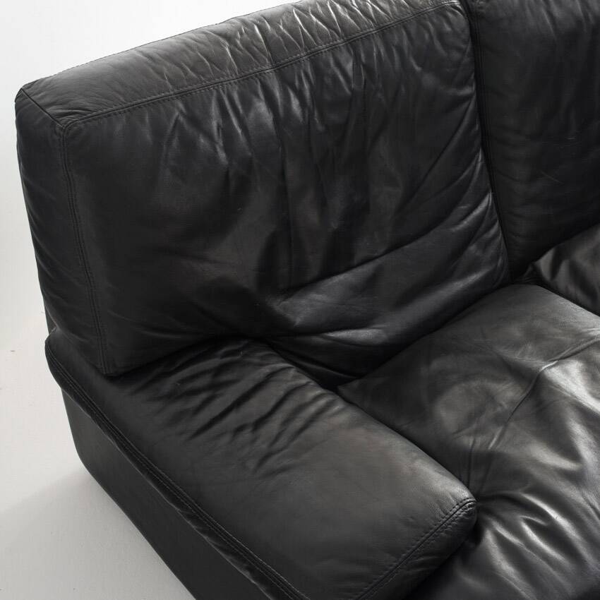 Black leather two-seater sofa. Roche Bobois edition. France, 1980s.