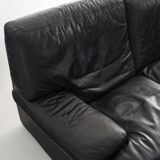 Black leather two-seater sofa. Roche Bobois edition. France, 1980s.