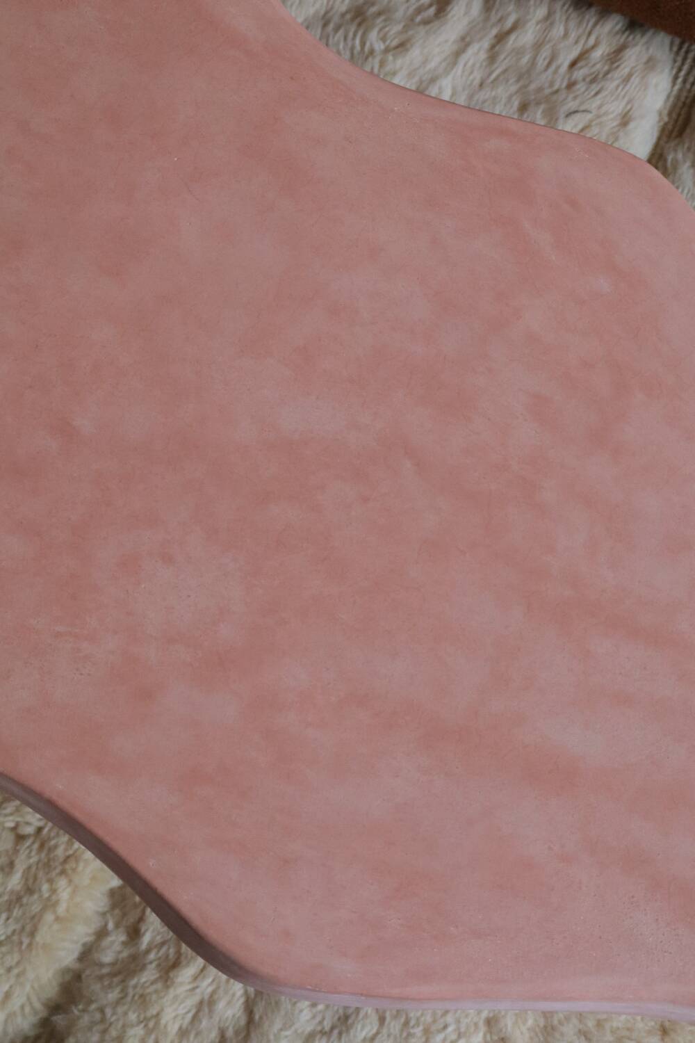 Organic shaped coffee table in pink teracotta tadelakt