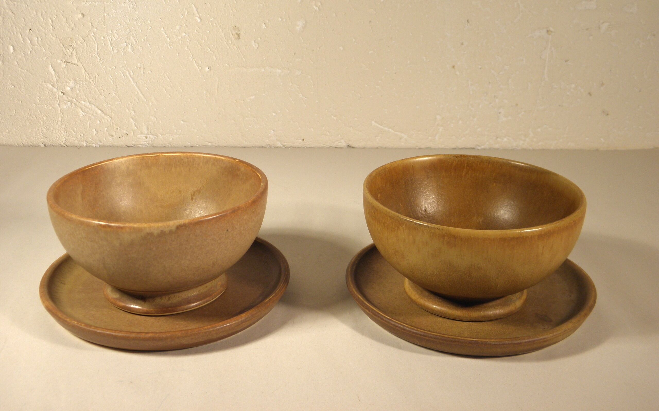Two sandstone bowls and saucers