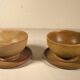 Two sandstone bowls and saucers