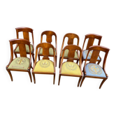 8 wooden gondola chairs with green and blue fabric.