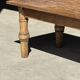 Brown Indonesian teak coffee table, with a border and cylindrical legs H40 L103.