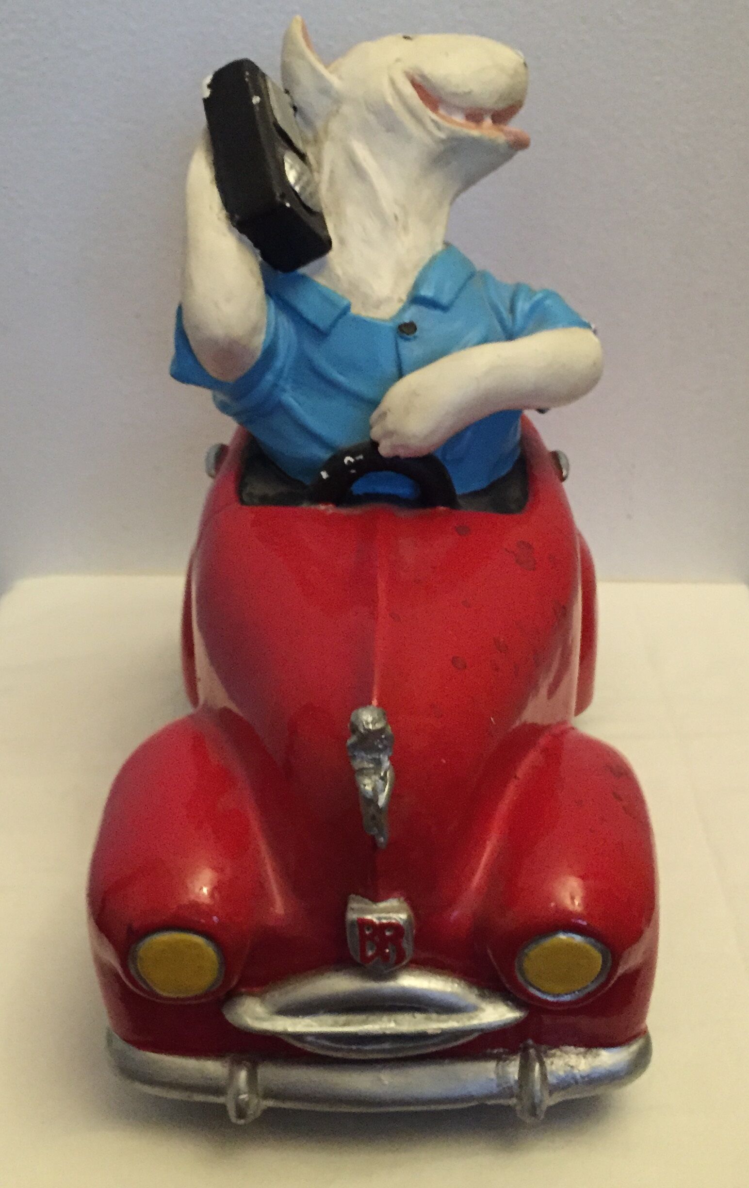Dog toy driving his red car