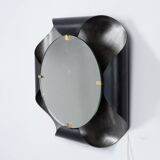 Mirror in curved metal and golden brass. 1970s.