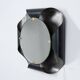 Mirror in curved metal and golden brass. 1970s.
