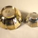 Two brass trundle cups