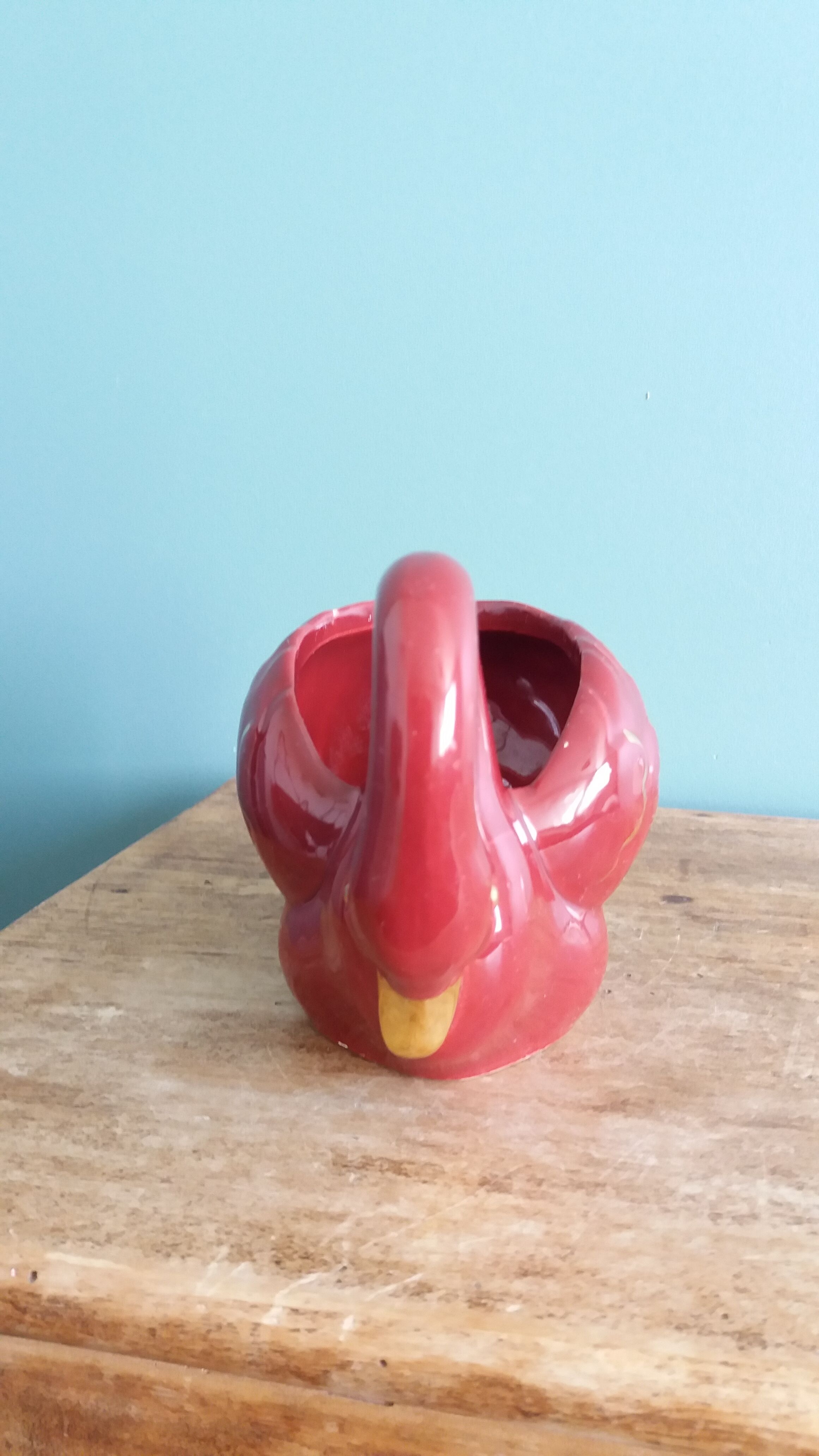 Poet Laval swan hides zoomorphic pot in burgundy ceramic.
