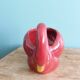 Poet Laval swan hides zoomorphic pot in burgundy ceramic.