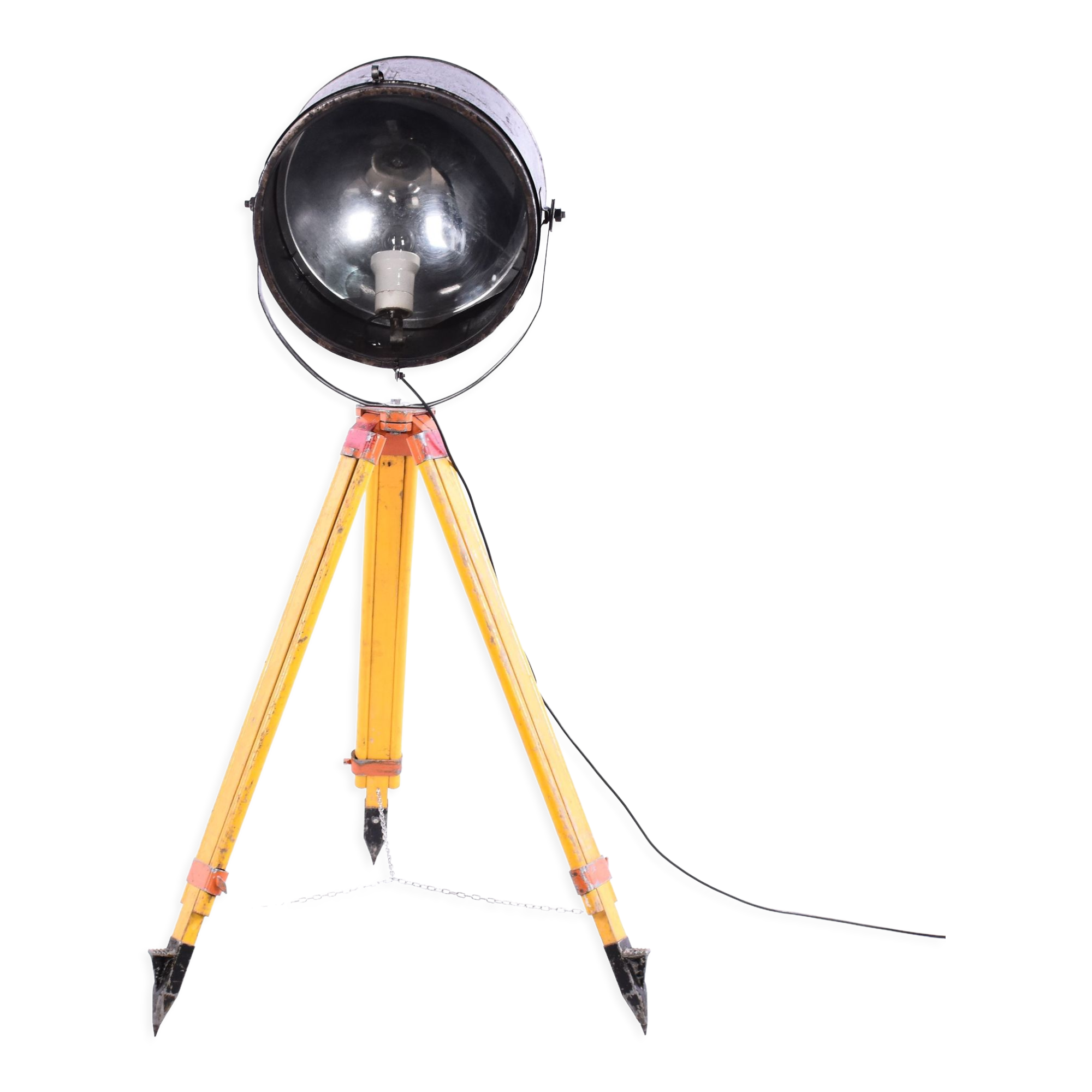 Old industrial spot on wooden tripod