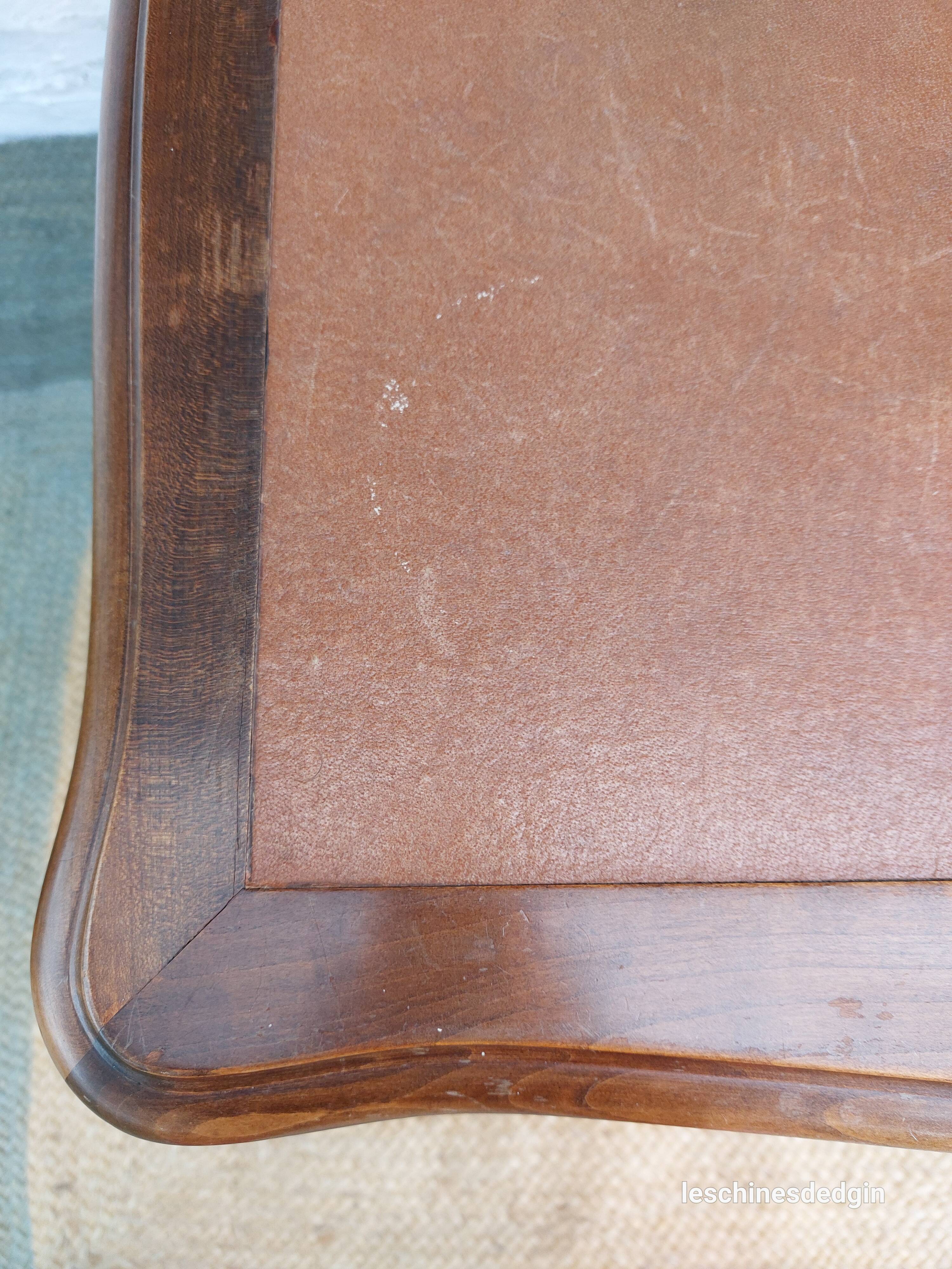 Louis XV style desk in wood, with a brown leather top.