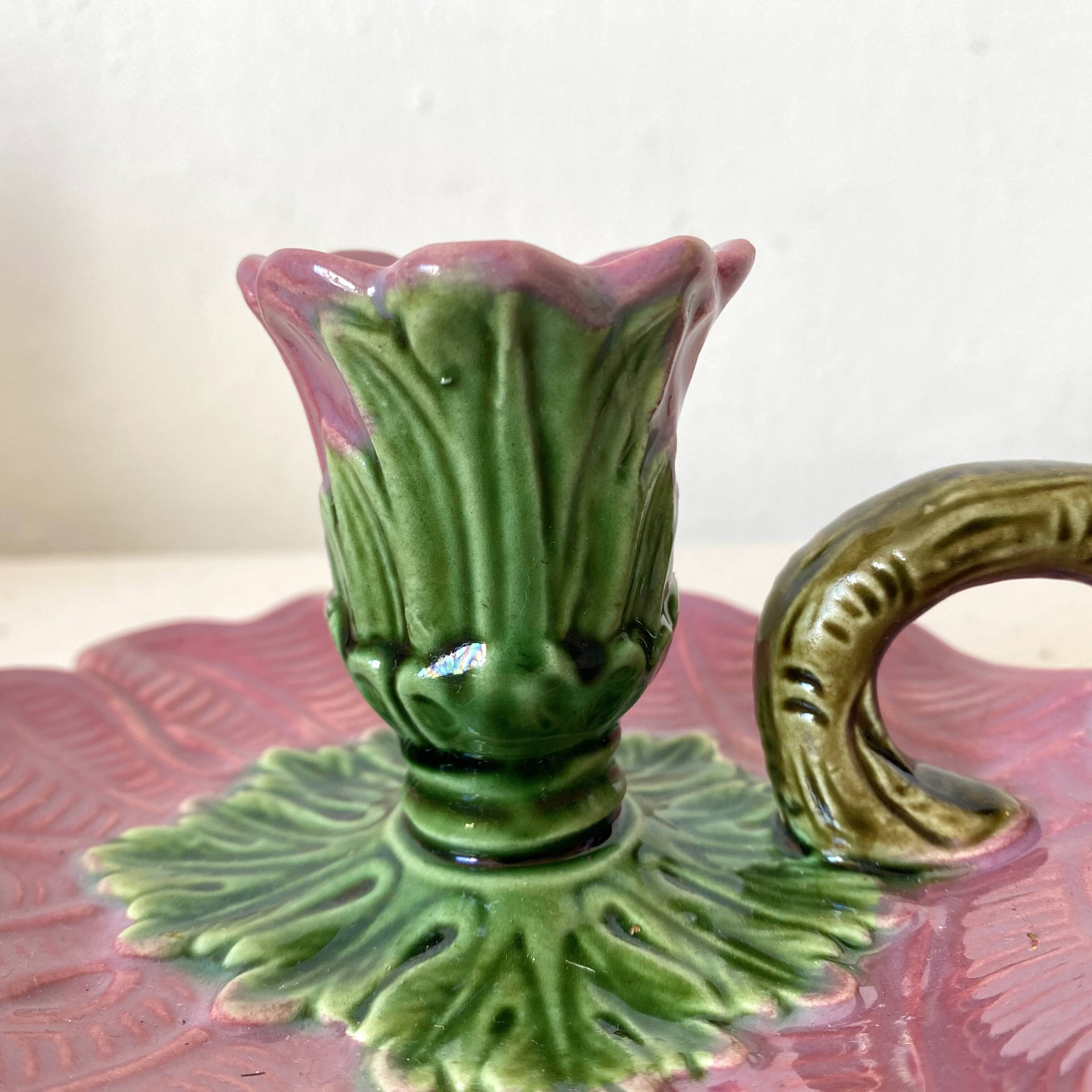 Antique slip candlestick depicting a flower