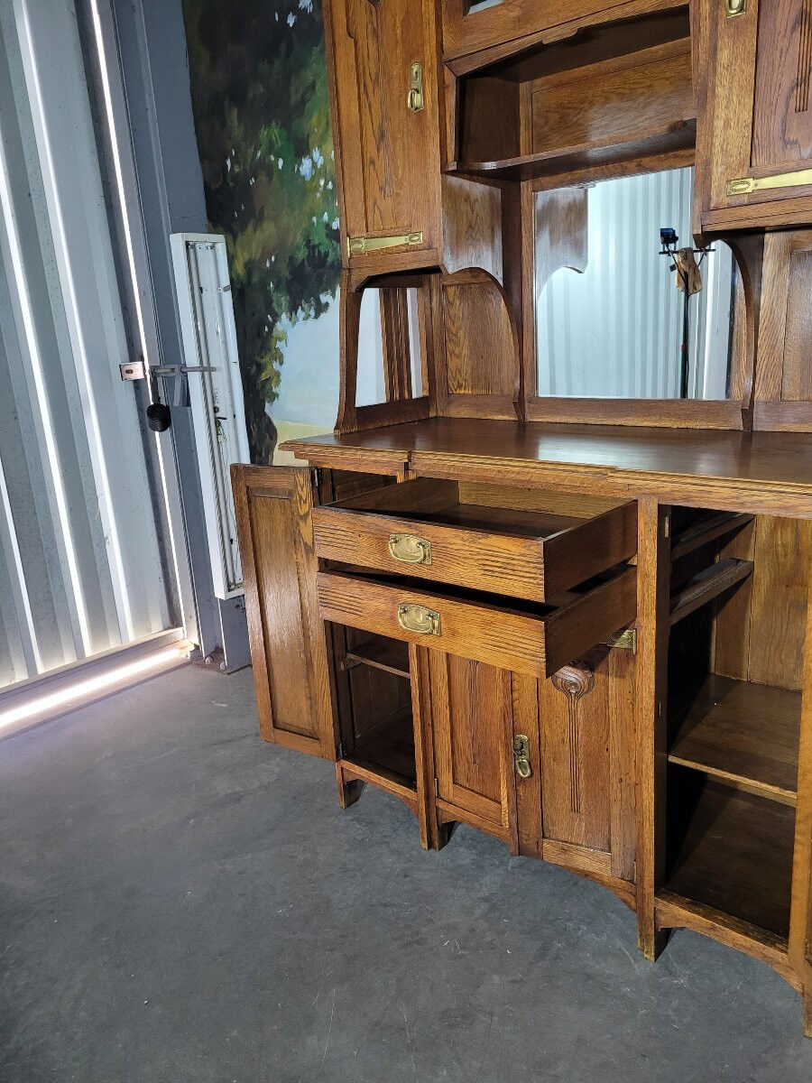 Glass-fronted oak sideboard from the Art Nouveau period.