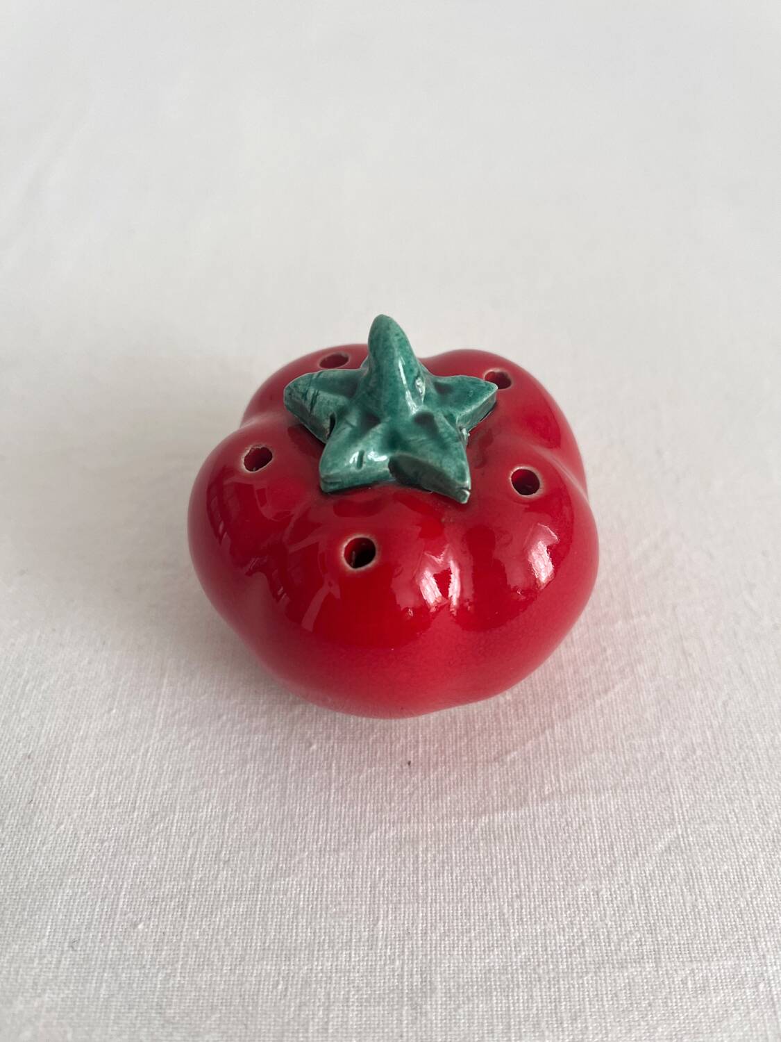 Vintage tomato salt or pepper shaker in slip