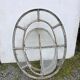 Bull's-eye window from the 19th century in iron (with opening).
