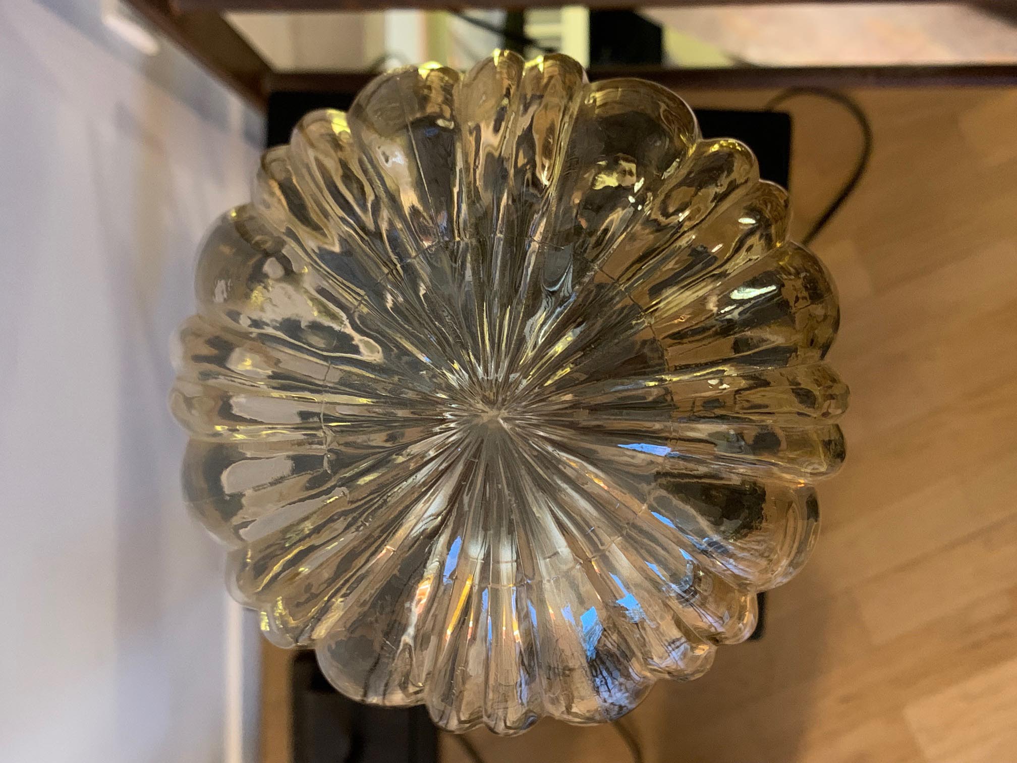 Table lamp with an antique golden streaked globe and a golden foot