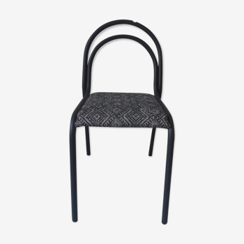 Indus chair with tubular structure in slate gray metal waxed finish, upholstered seat.