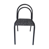 Indus chair with tubular structure in slate gray metal waxed finish, upholstered seat.