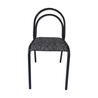 Indus chair with tubular structure in slate gray metal waxed finish, upholstered seat.