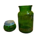 Green apothecary jar with golden patterns
