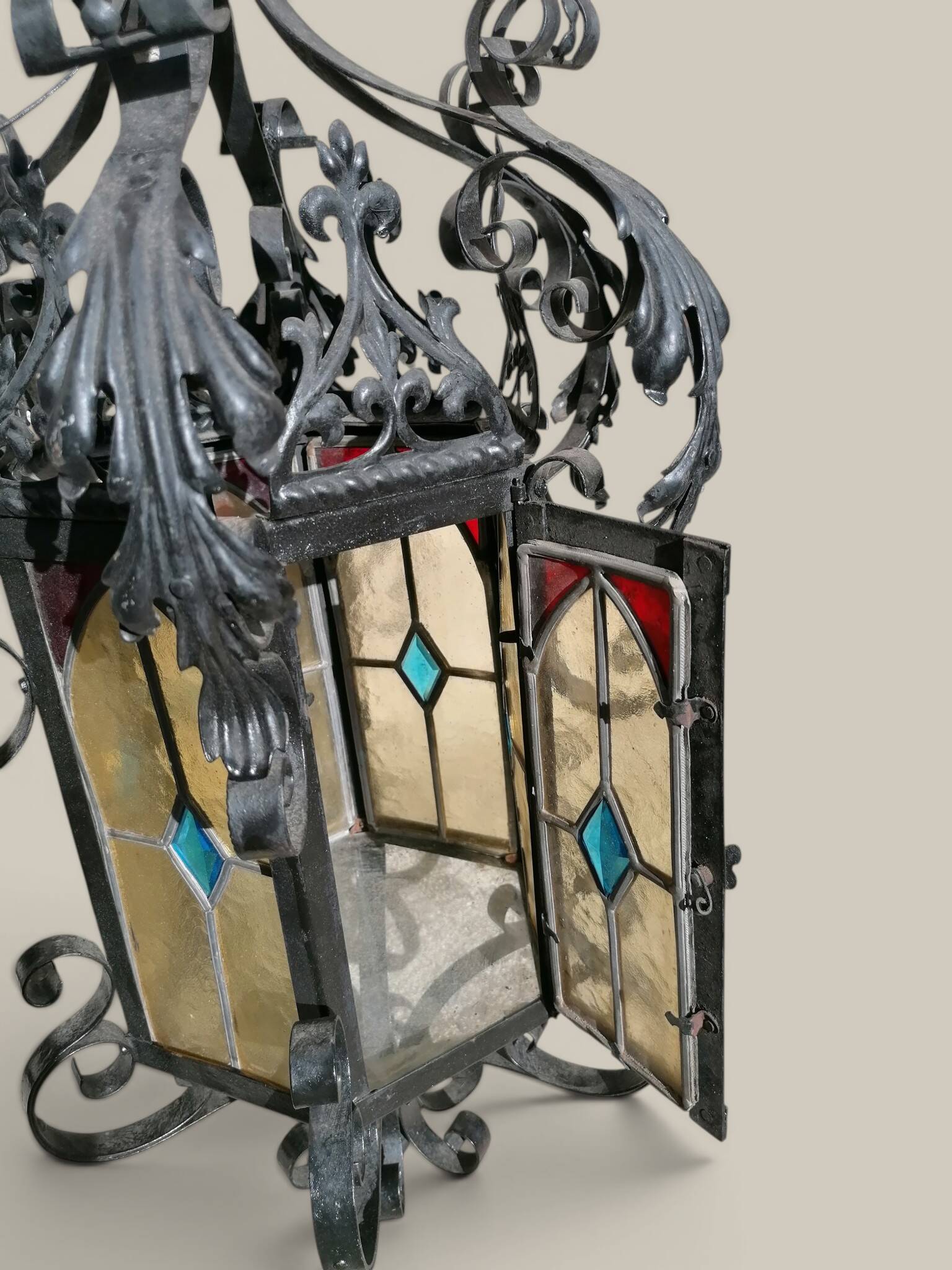 Black wrought iron lantern with stained glass. Medieval, Gothic decoration.