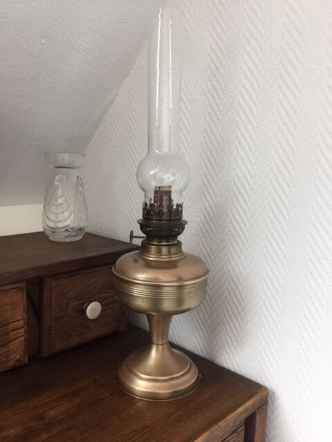 Old oil lamp on pink copper stand