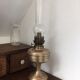 Old oil lamp on pink copper stand