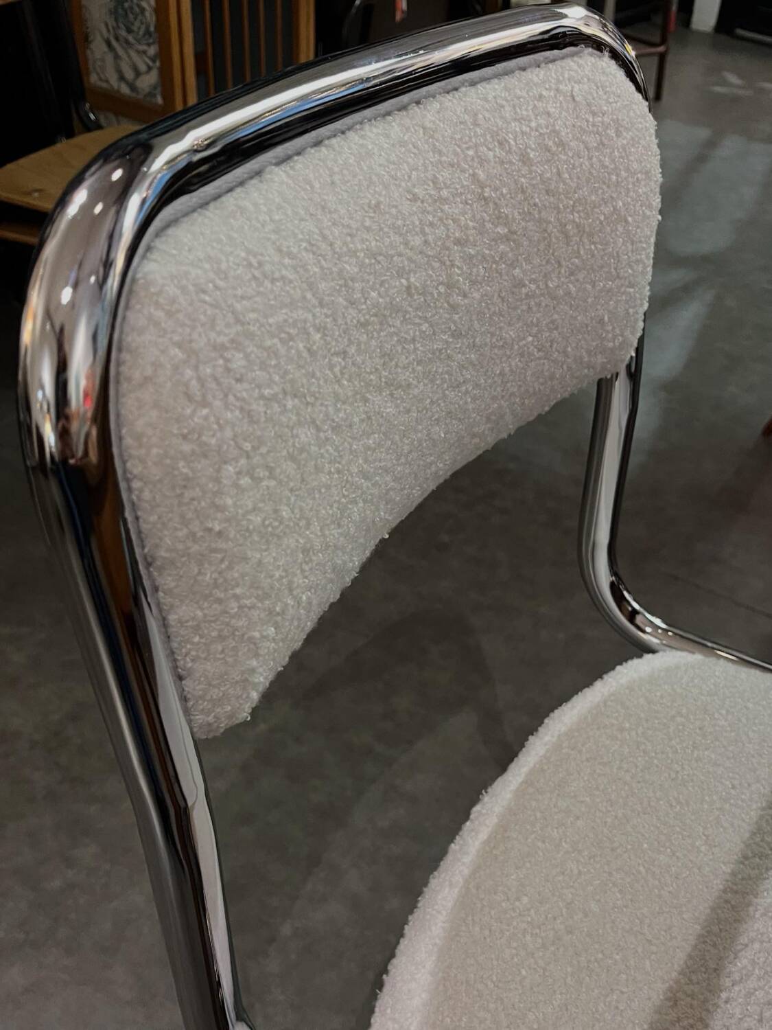 Pair of chrome chairs upholstered in boucle fabric.