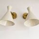 Pair of Italian wall sconces in brass and lacquered iron, 1950s design.