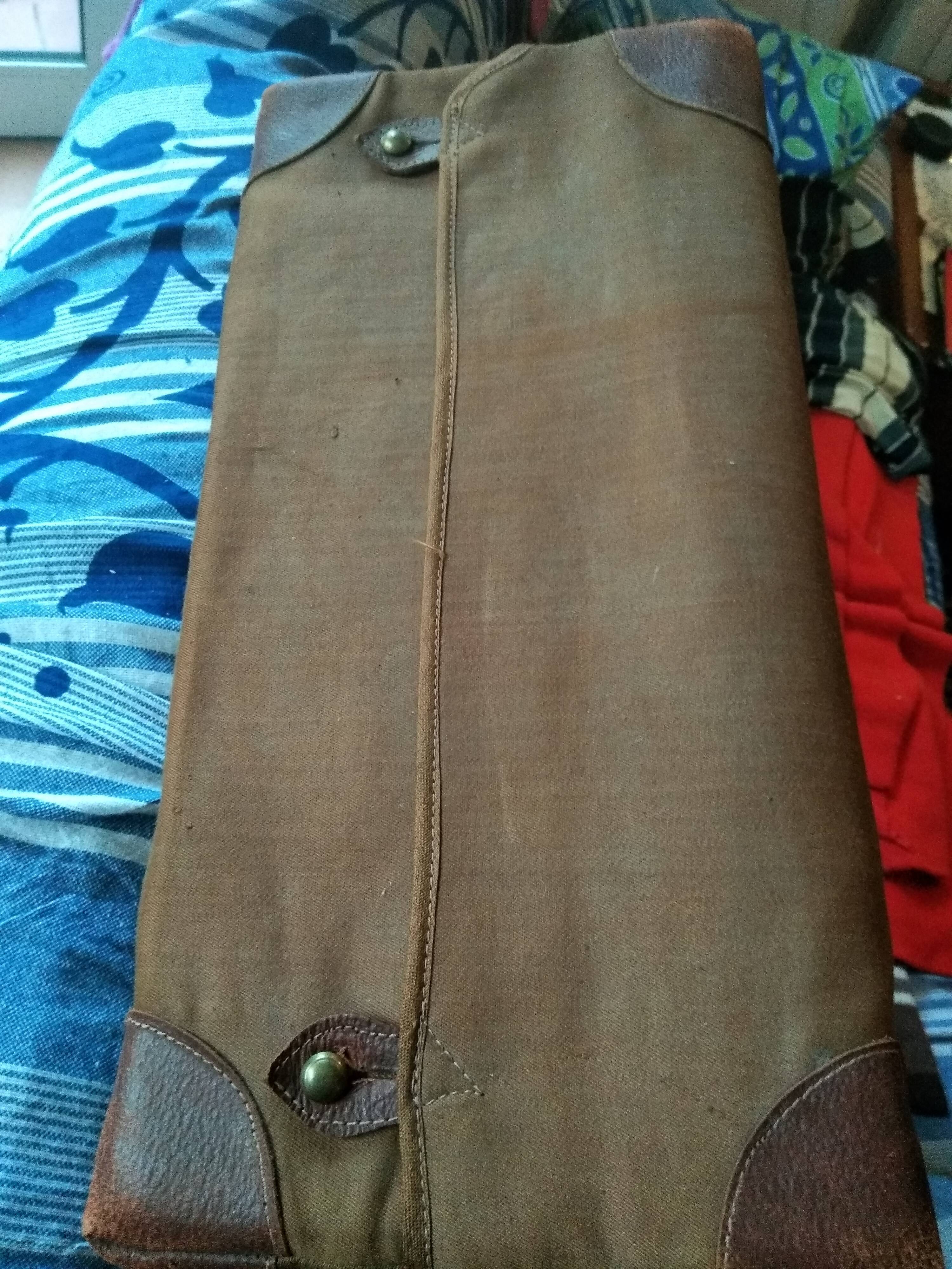 Old leather suitcase with its protective cover
