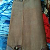Old leather suitcase with its protective cover