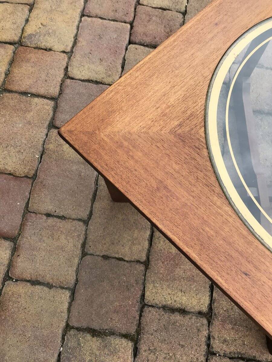 Round glass coffee table with a gold border and brown teak structure, Astro 1960s style.