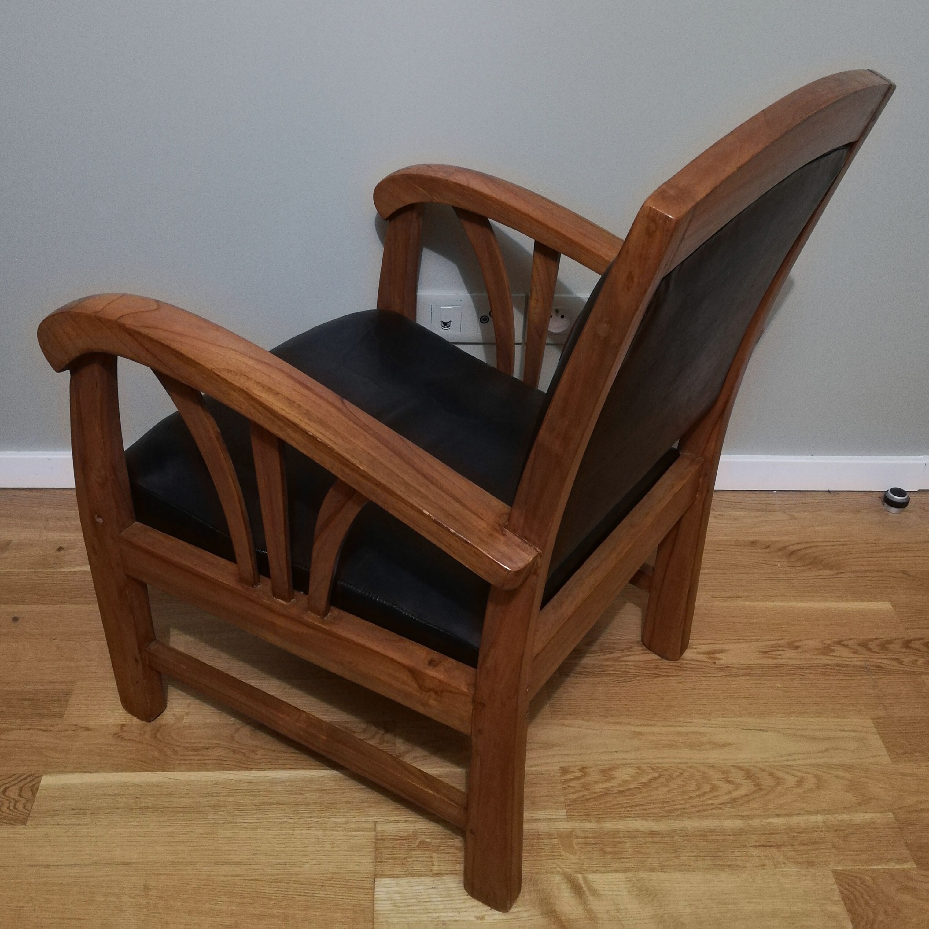 Colonial armchair in teak and black leather