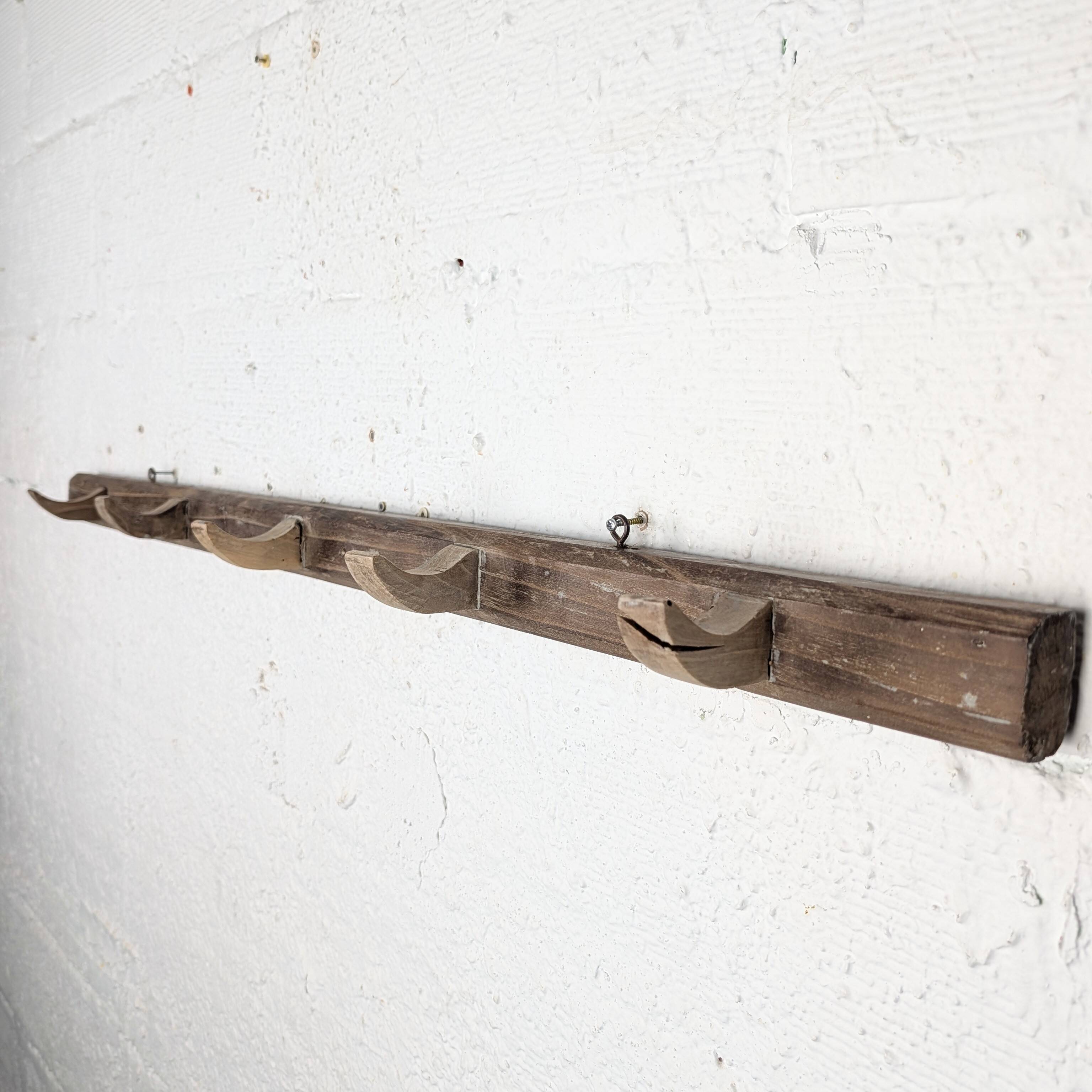 Handcrafted wall coat rack in raw wood