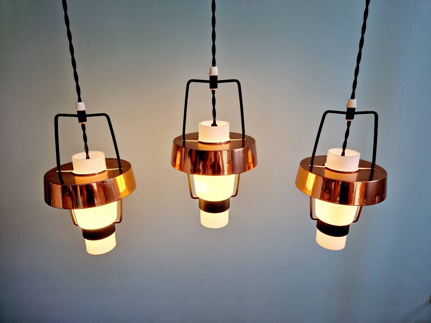Trio of Scandinavian pendant lights in opaline and copper metal, 1960s