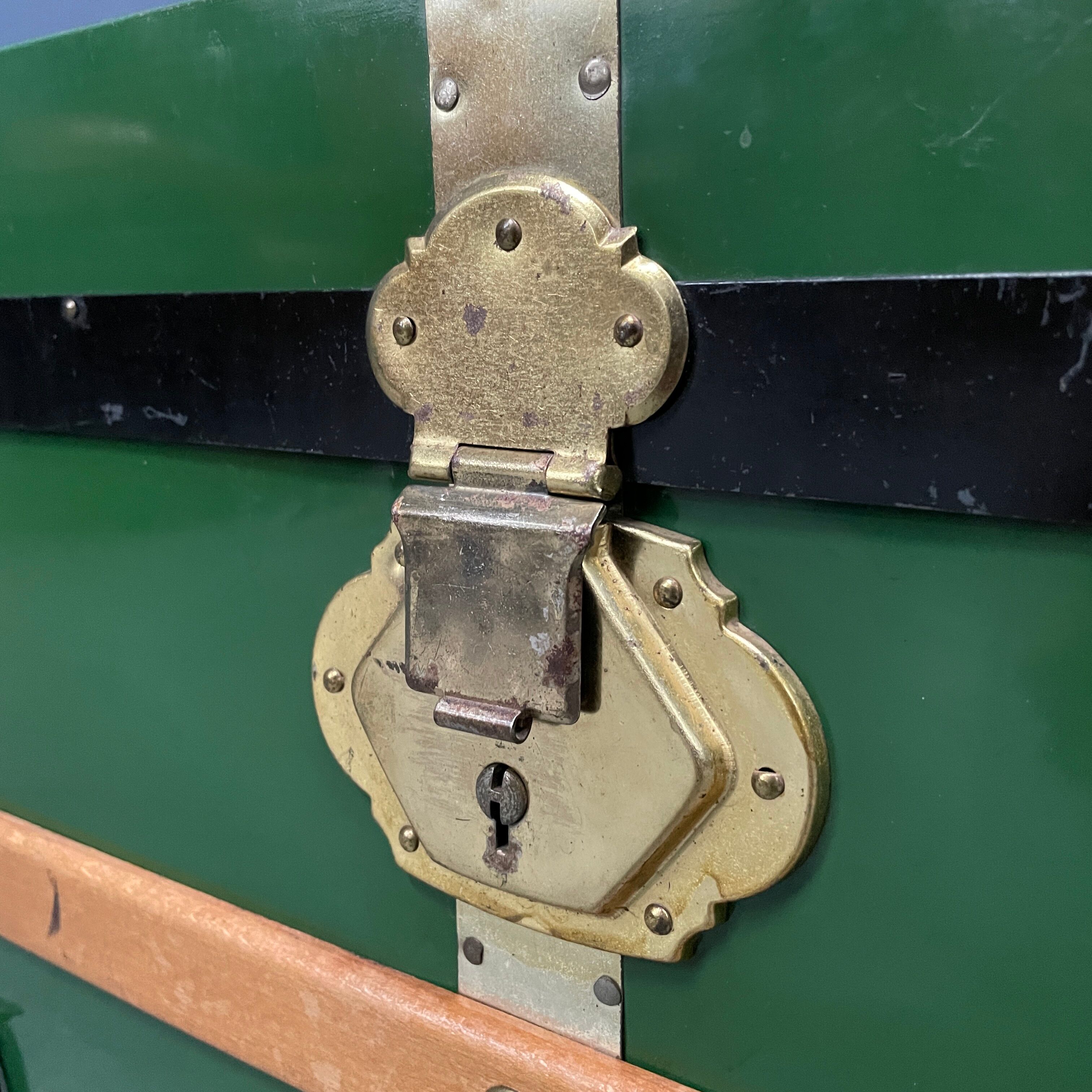Green metal trunk with wooden sleds