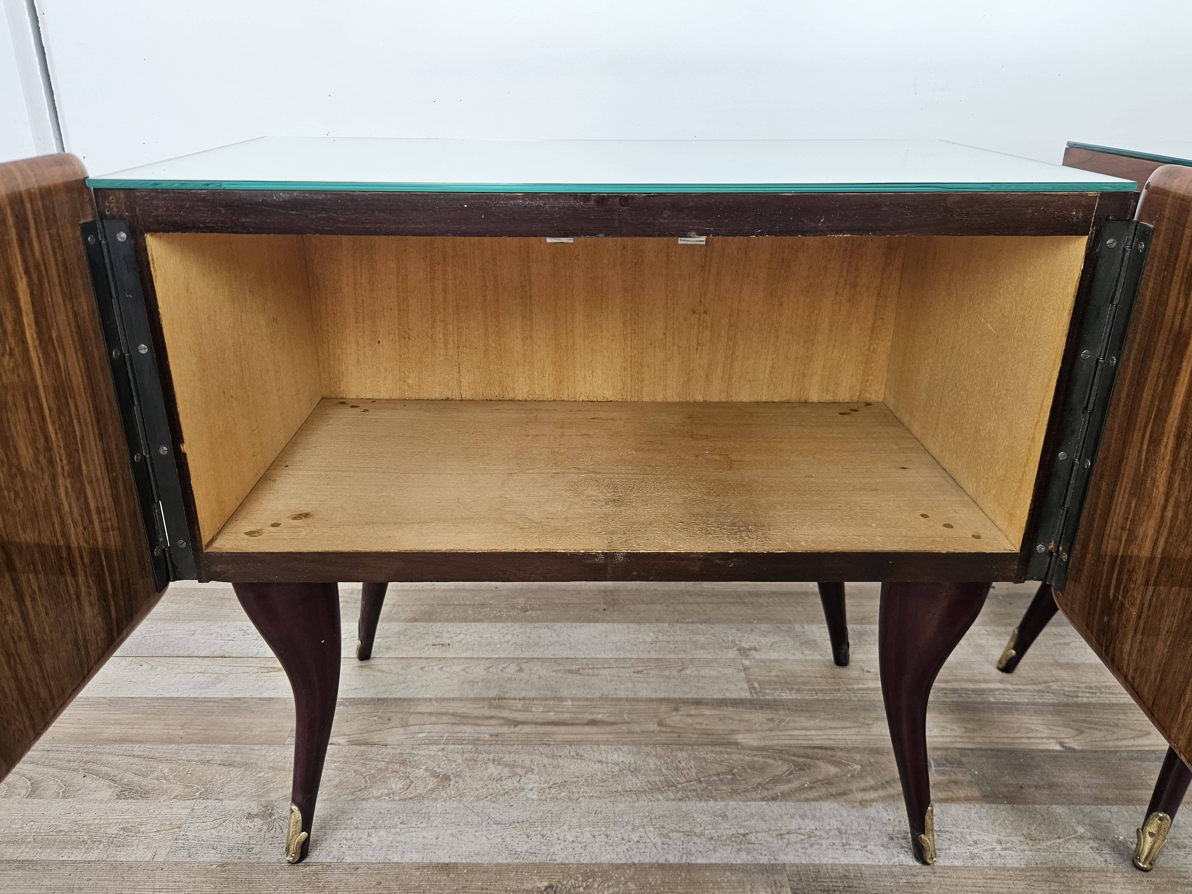 Mid-century mahogany bedside tables with mirrored tops.